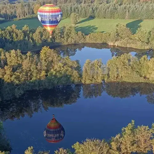 Montgolfière qui vole au dessus d'un étang